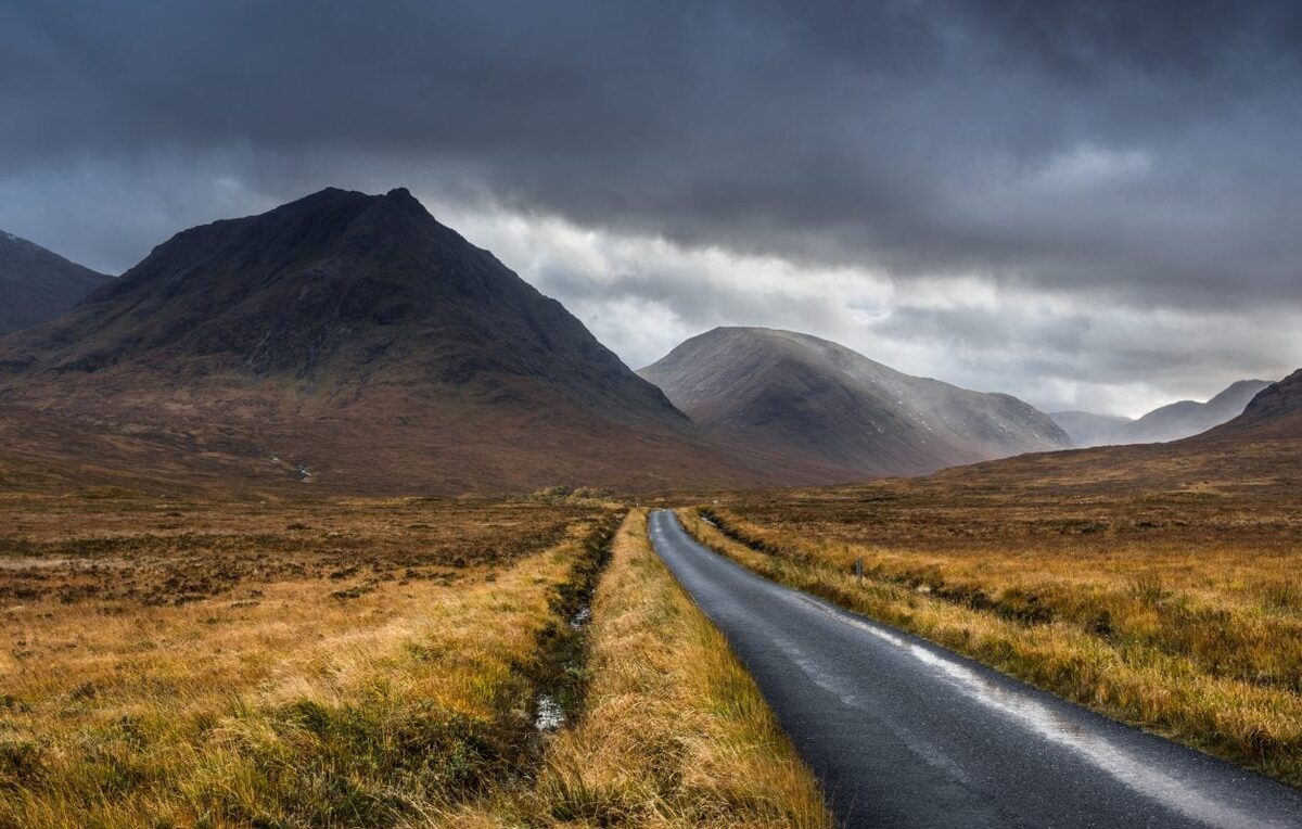 The road through Glen Etive towards the Buachaille under a stormy sky.