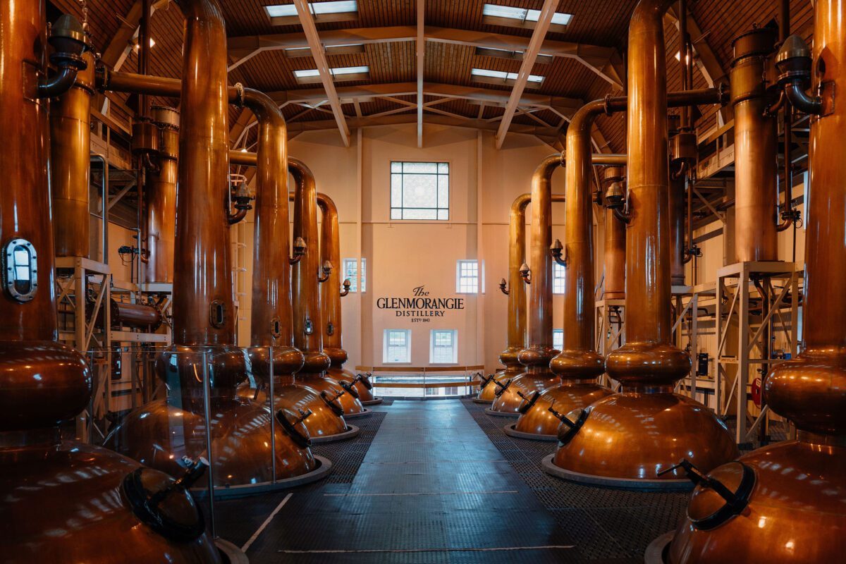 Copper stills line the Glenmorangie Distillery still house in rows