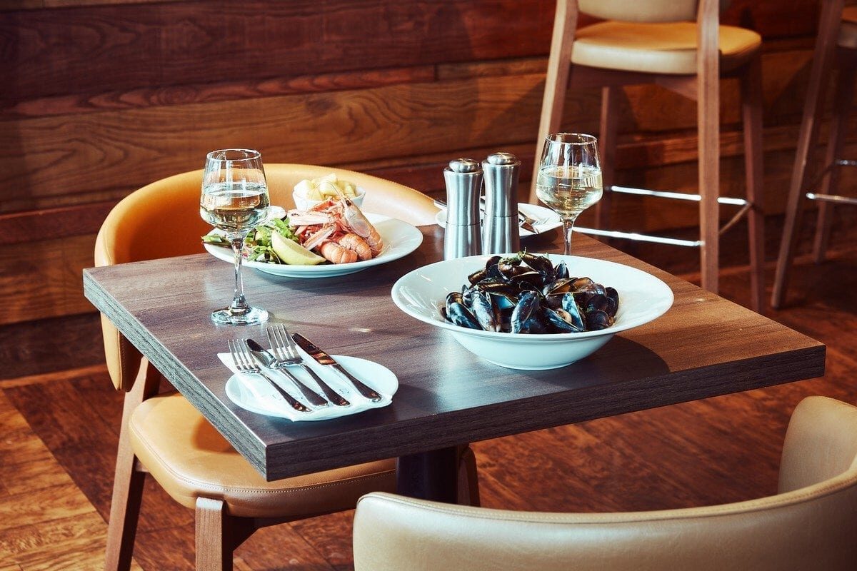Mussels and prawn cocktail with white wine on a restaurant table