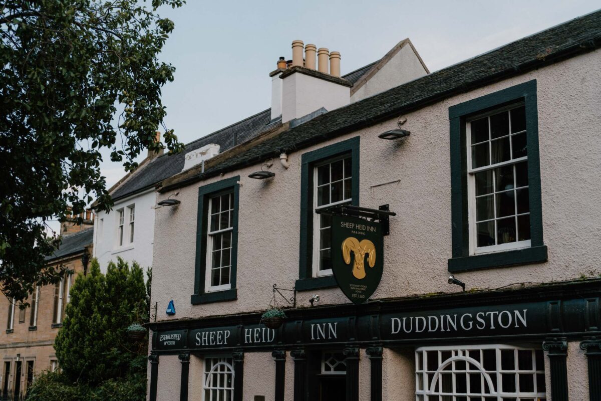 White-washed Sheep Heid Inn Duddingston with black-framed windows and a ram's head sign
