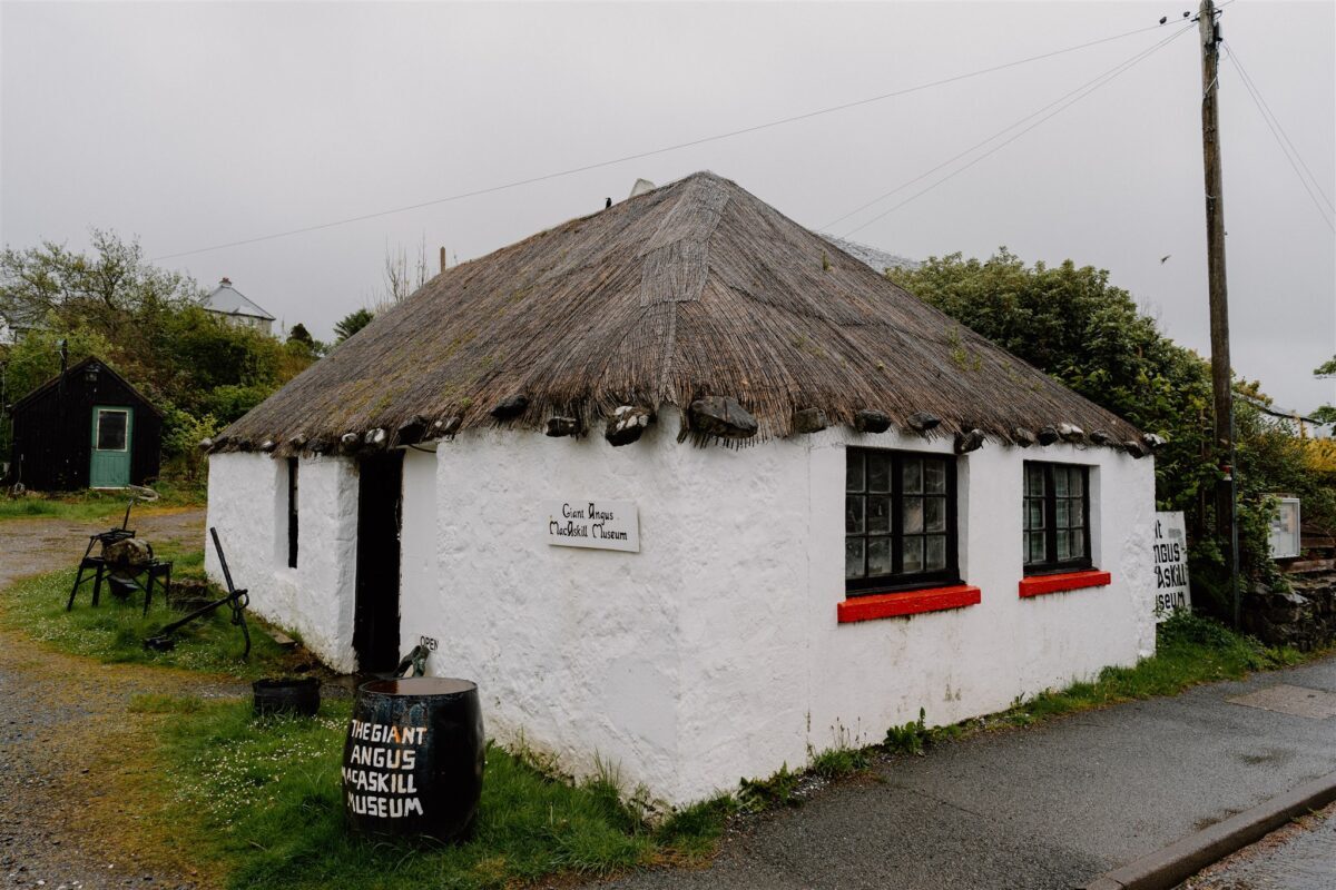 Whitewashed thatched cottage with a "Regiant Angus Skye Museum" sign outside