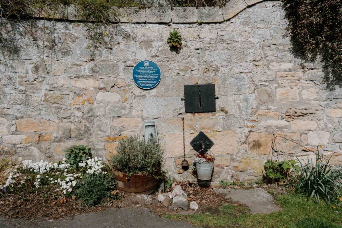 The Lockit Well set into a stone wall in Culross.