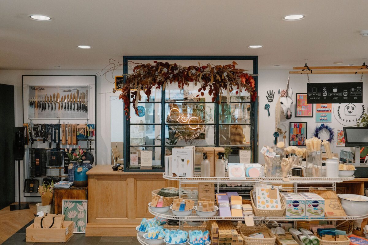 Gift shop interior with dried flower garland above a wooden counter
