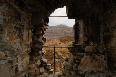 The view through a ruined window of Caisteal Maol to the water and hills.