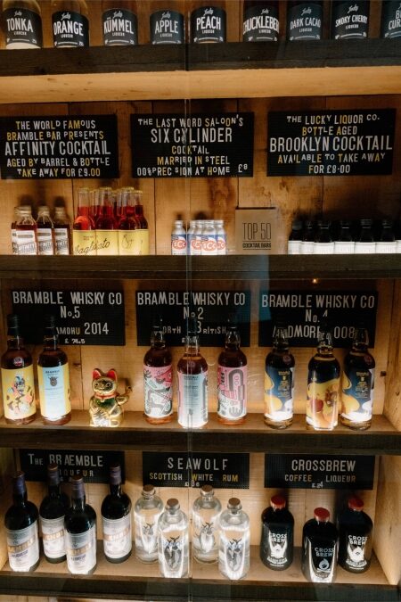 Shelves of bottled cocktails at Bramble, including Affinity, Six Cylinder and Brooklyn Cocktail