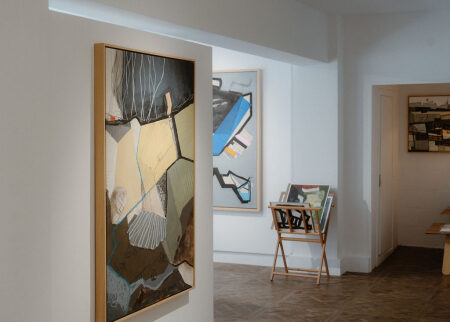 A large abstract painting and framed works in the white gallery.