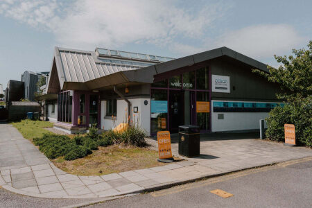 The timber-clad visitor centre and its welcome sign.