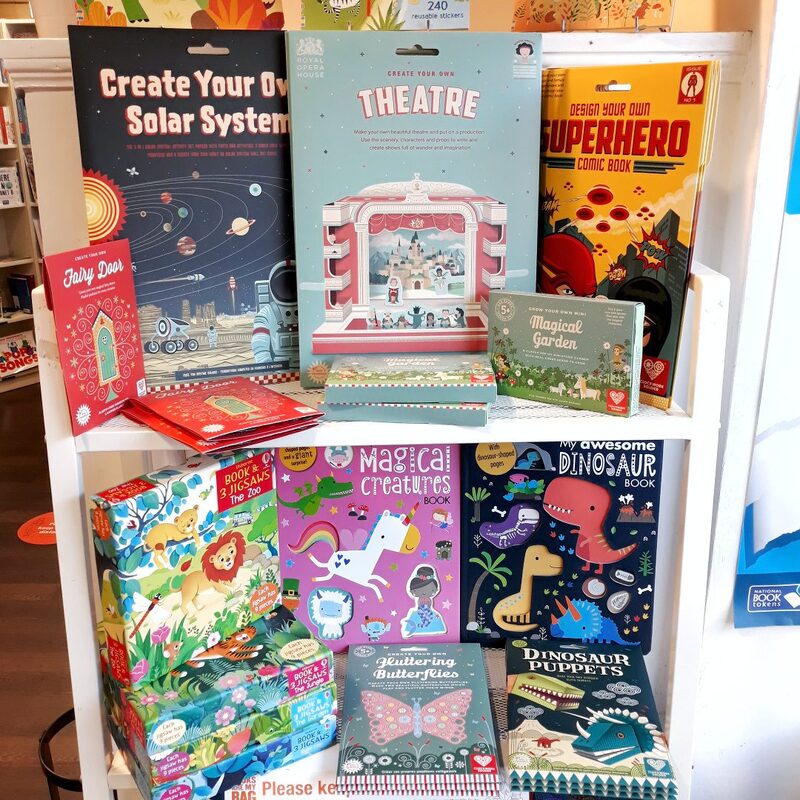 Shop shelf displaying children's craft kits including Create Your Own Solar System and Theatre